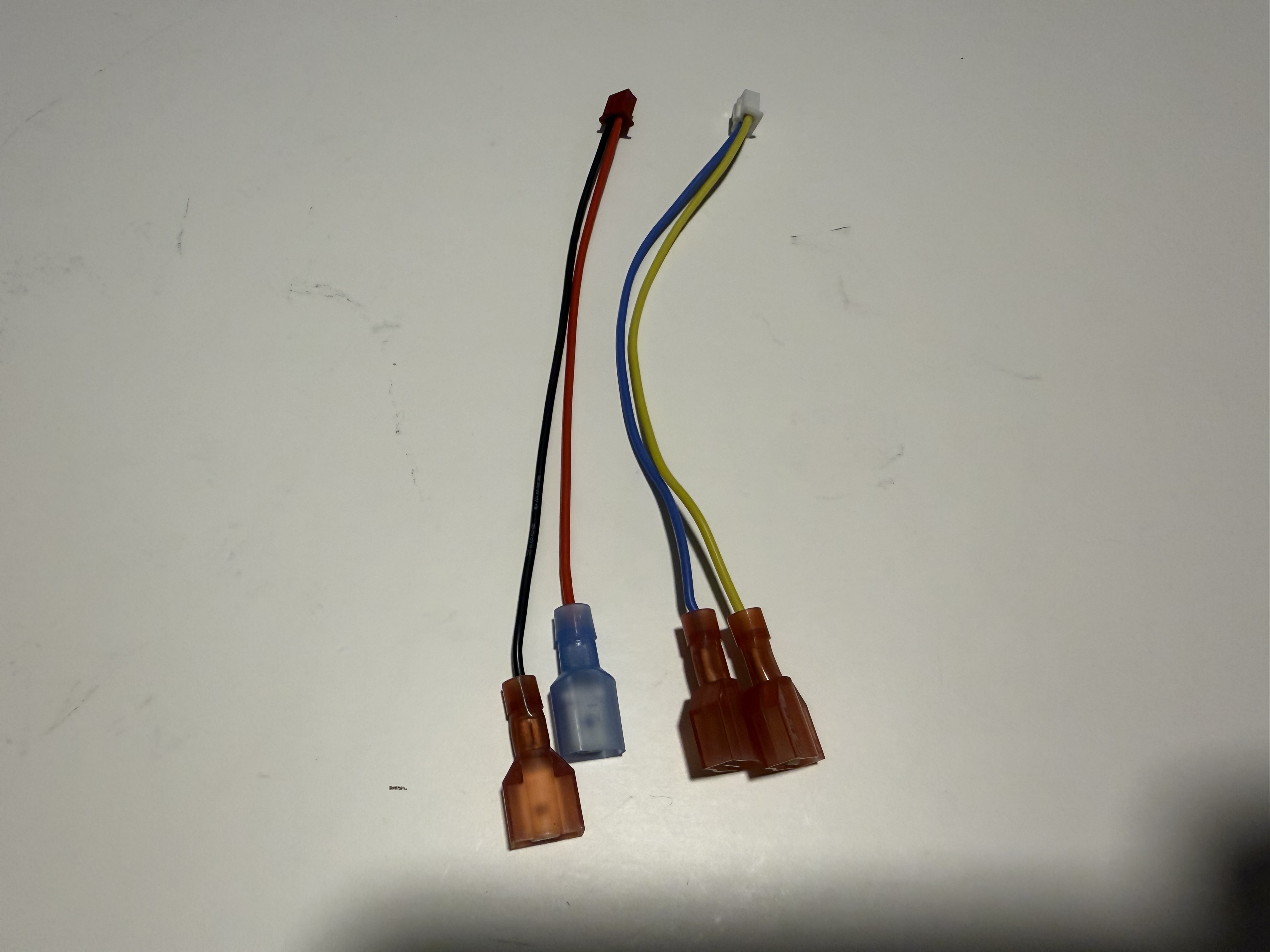 ProtonPal JST wiring assemblies with red, black, blue, and yellow wires and spade terminals