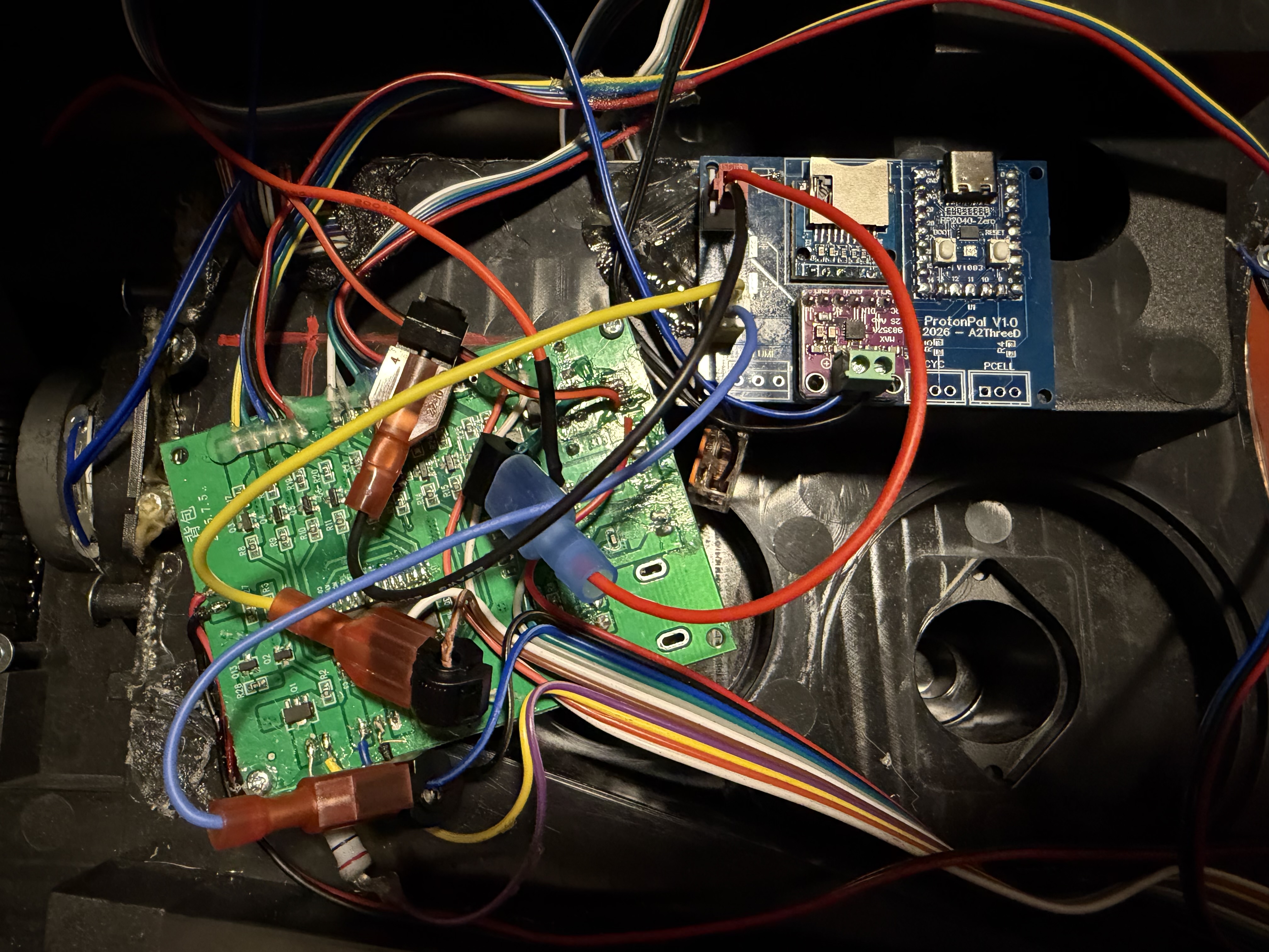 ProtonPal installed beside the factory PCB with the tap wiring connected