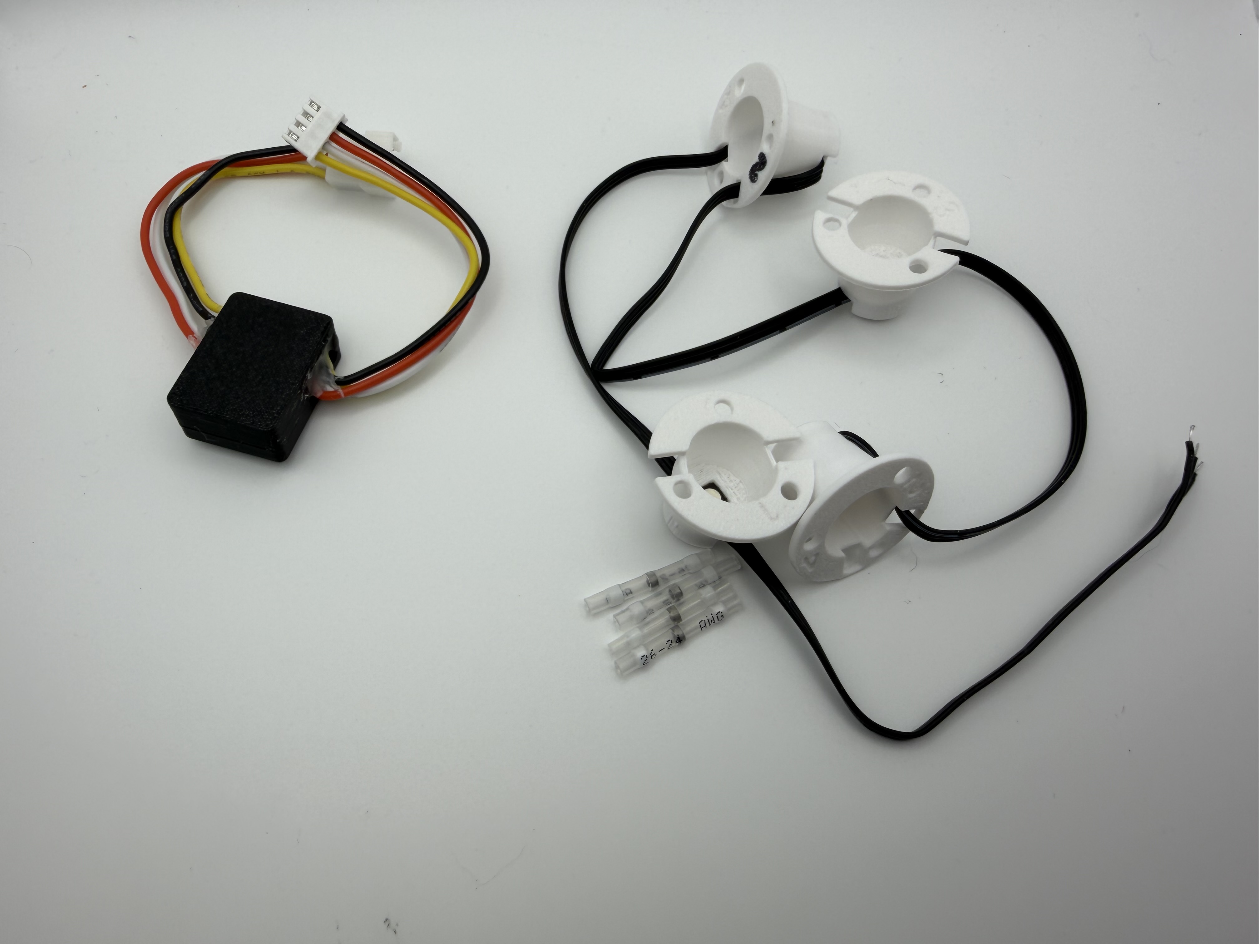 Basic Recessed Emitter Devices kit with four reflector cups, LED wiring, connector, and solder-seal connectors