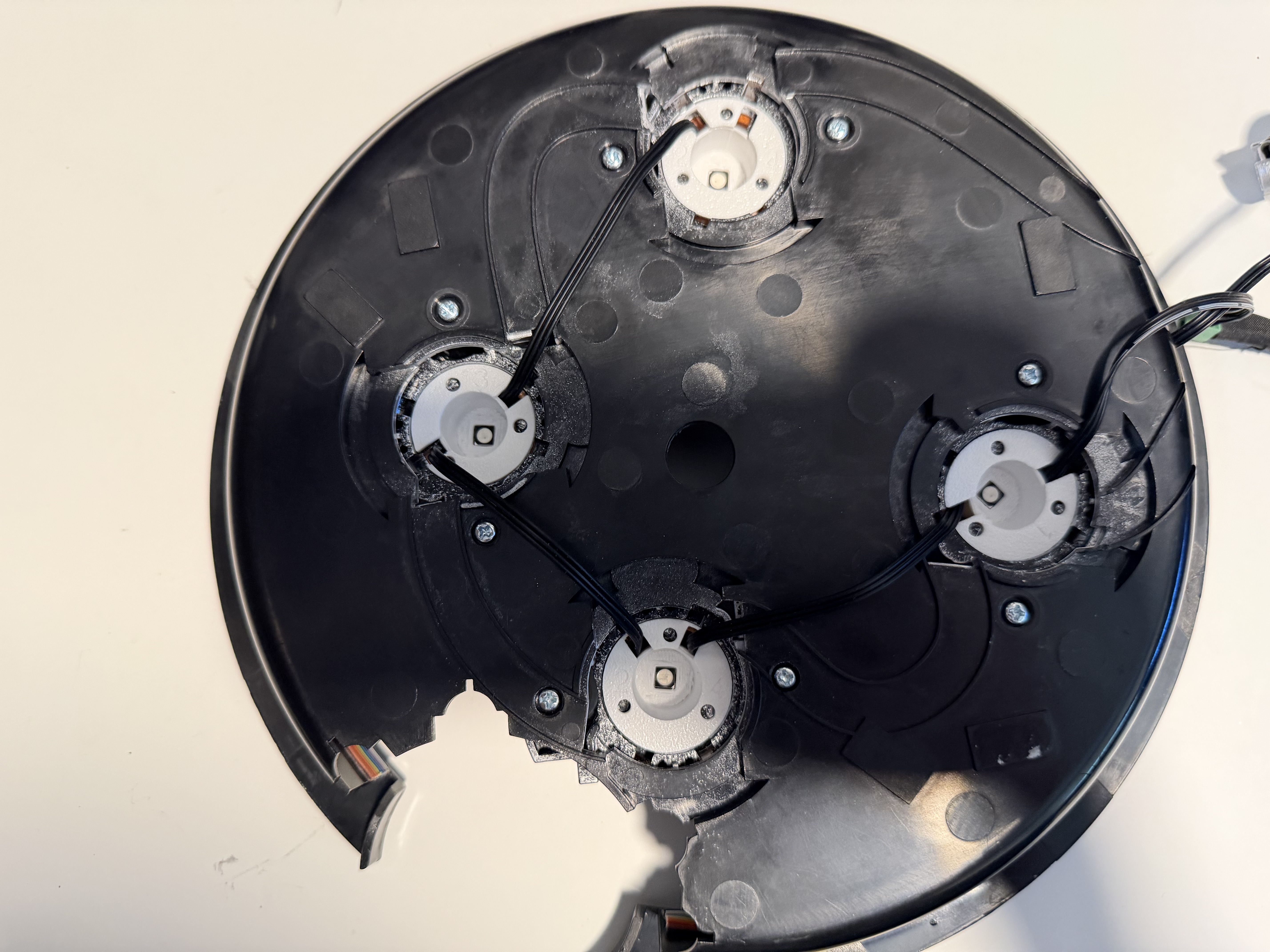 All four white reflector cups installed in the cyclotron lid with their wires routed